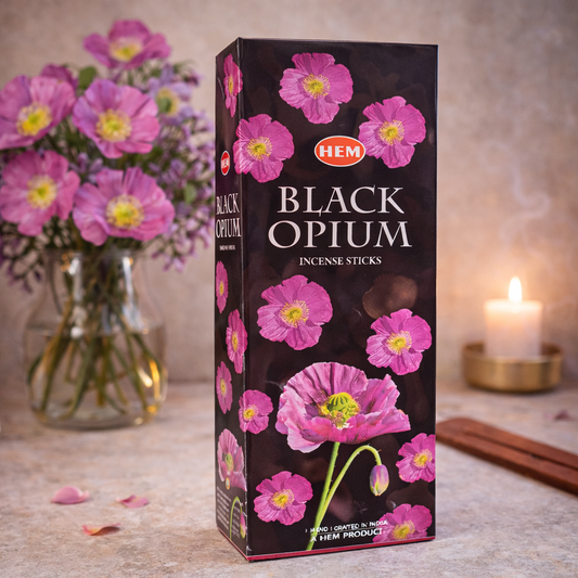 HEM Black Opium incense sticks box with pink flowers and candle in the background