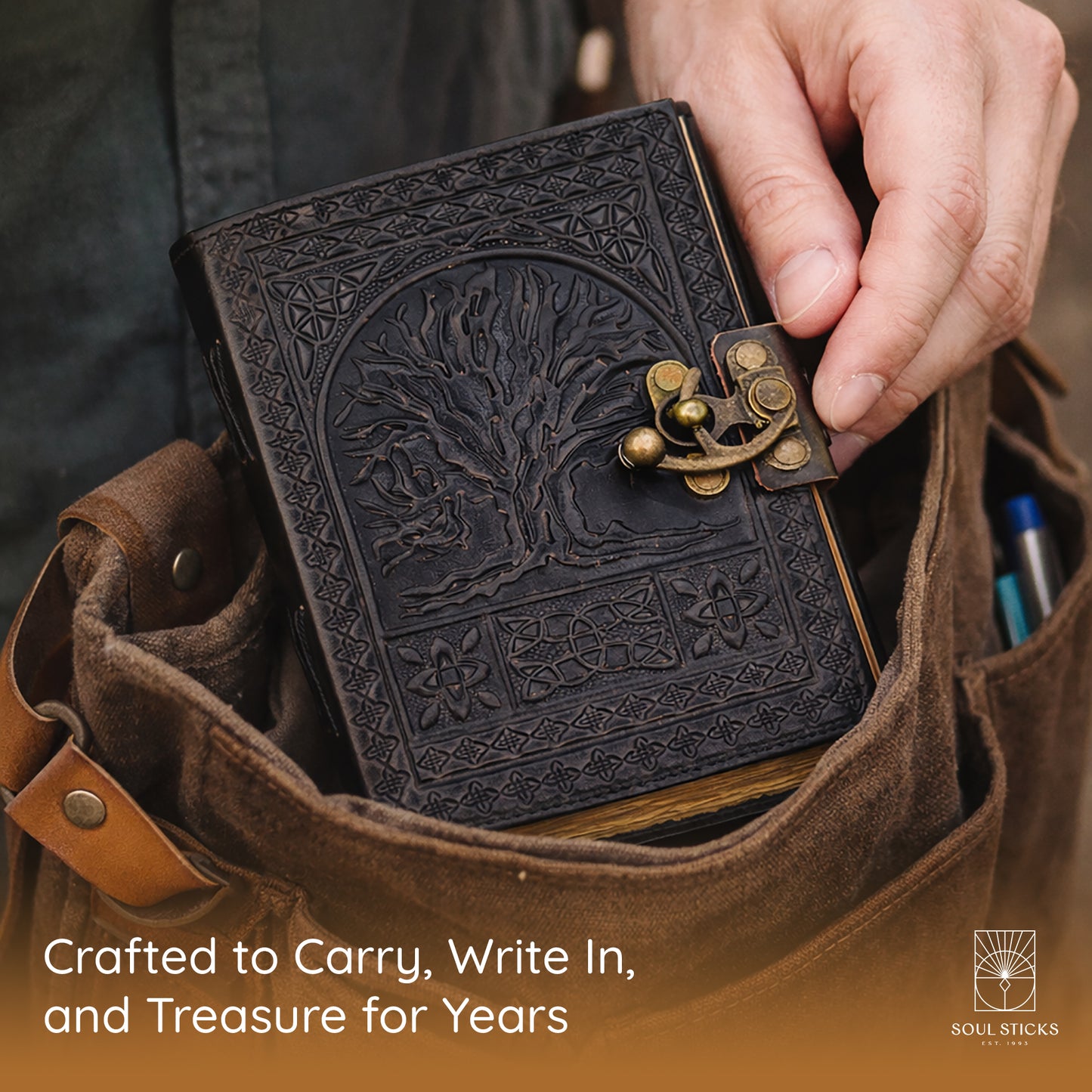 Angled view of the Tree of Life leather journal in a lifestyle setting