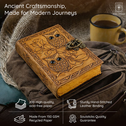 Closed Owl leather journal resting on a fabric surface