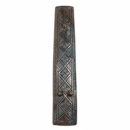 Back view of a silver-tone 7 chakra incense stick holder with embossed geometric patterns and three raised feet, shown vertically on a white background.
