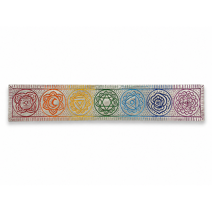 Silver-tone 7 chakra incense stick holder with seven engraved rainbow chakra symbols arranged across a long rectangular tray, shown horizontally on a white background.