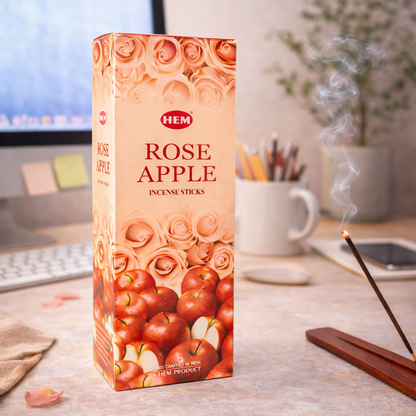 HEM Rose Apple incense sticks box on a desk with burning incense and office supplies