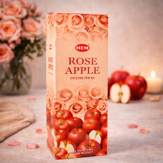 HEM Rose Apple incense sticks box with roses, apples, and candle in the background