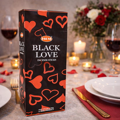 HEM Black Love incense sticks box on a romantic dinner table with candles and red wine
