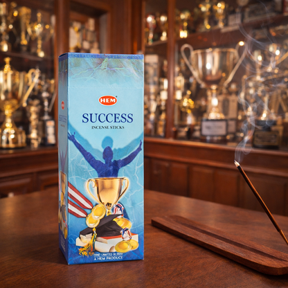 HEM Success incense sticks box with burning incense in front of trophy shelves