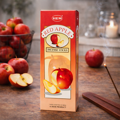 HEM Red Apple incense sticks box with burning incense and fresh apples on a table