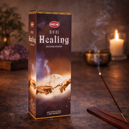 HEM Divine Healing incense sticks box with burning incense, candle, and crystal decor