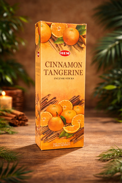 HEM Cinnamon Tangerine incense sticks box on a wooden table with greenery and candlelight