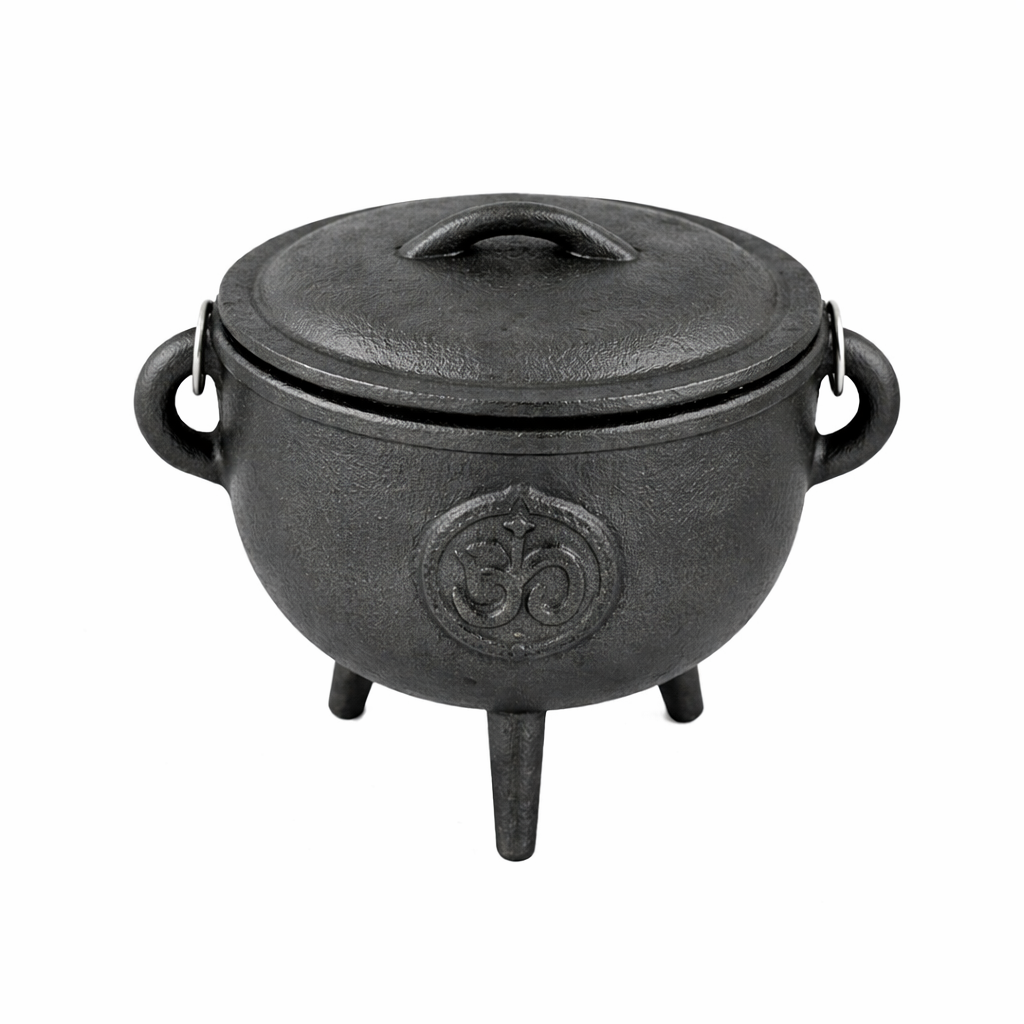 Hand holding the cast iron cauldron with lid & carry handle for rituals
