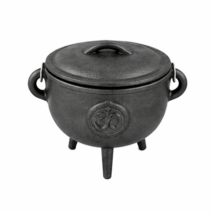 Hand holding the cast iron cauldron with lid & carry handle for rituals