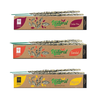 Three packages of natural smudge sticks, each labeled with a different herb name: Palo Santo, Copal, and White Sage. Each package showcases the sticks rolled in herbs at the bottom.