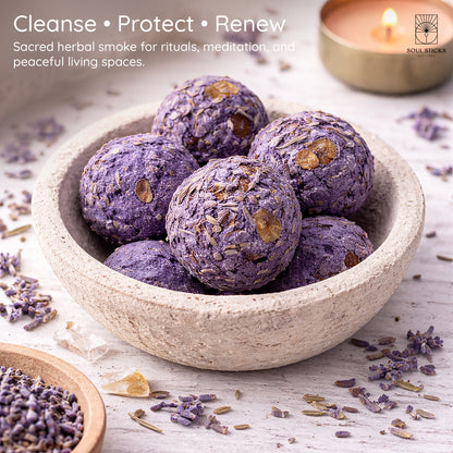 Lavender smudge bombs arranged in a bowl with herbs or flowers