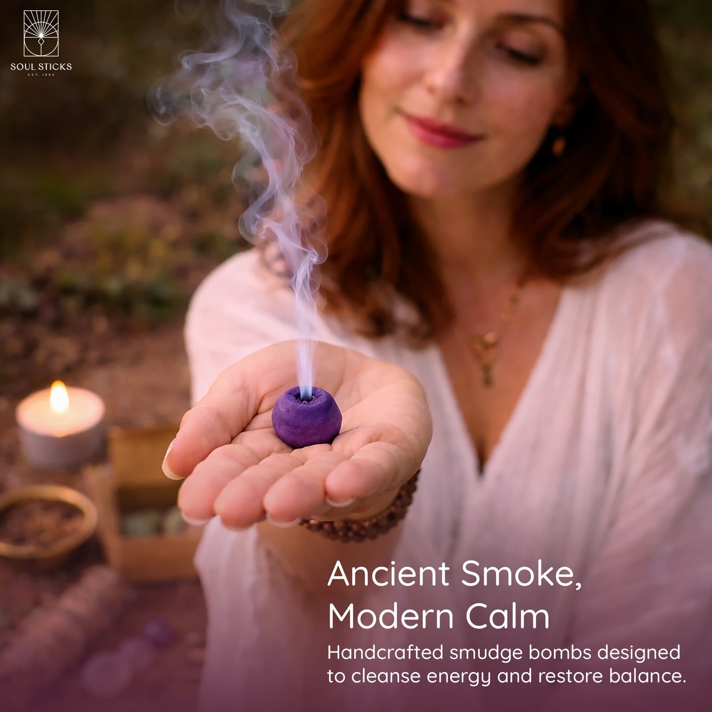 Hand holding a lit nag champa smudge bomb with smoke