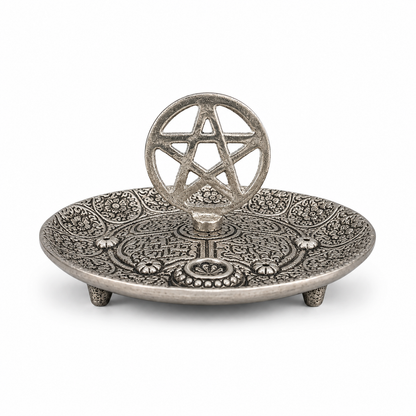 Antique silver pentagram incense holder with ornate engraved floral patterns, raised decorative details, and an upright pentacle centerpiece.