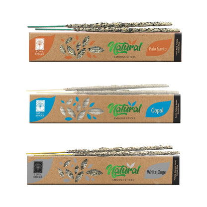 Three packages of natural smudge sticks, each labeled with a different herb name: Palo Santo, Copal, and White Sage. Each package showcases the sticks rolled in herbs at the bottom.