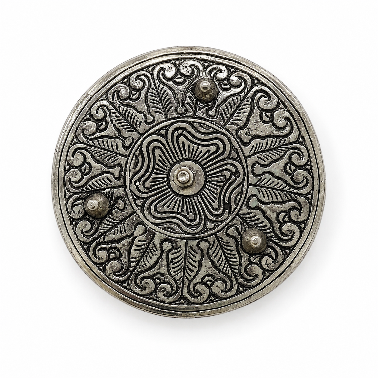 Bottom view of an antique silver incense holder featuring ornate floral and leaf engravings, a central fastener, and three raised feet on a white background.