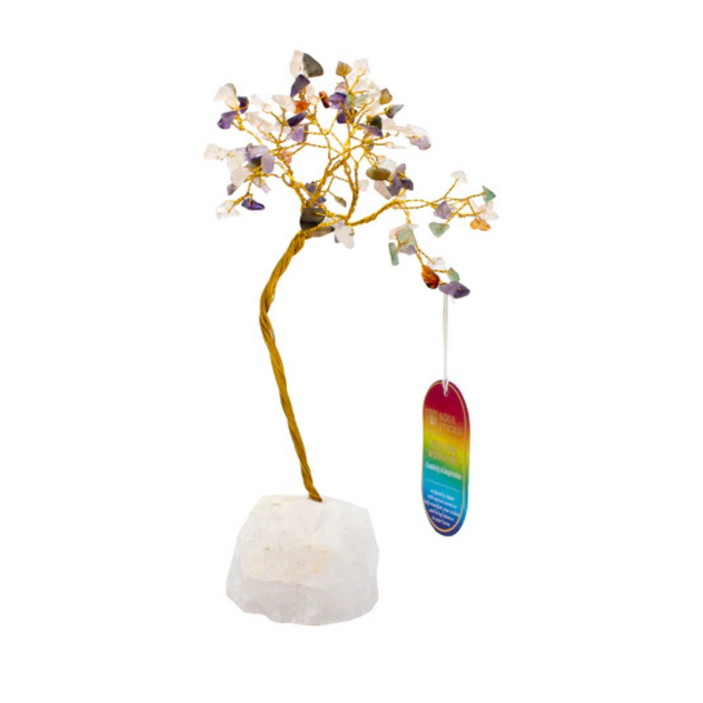 Decorative crystal tree with multicolored stones on a white base, against a white background.