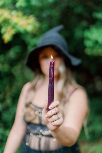 Decorative ritual bleeding candle with dripping wax for magical and mystical intentions.