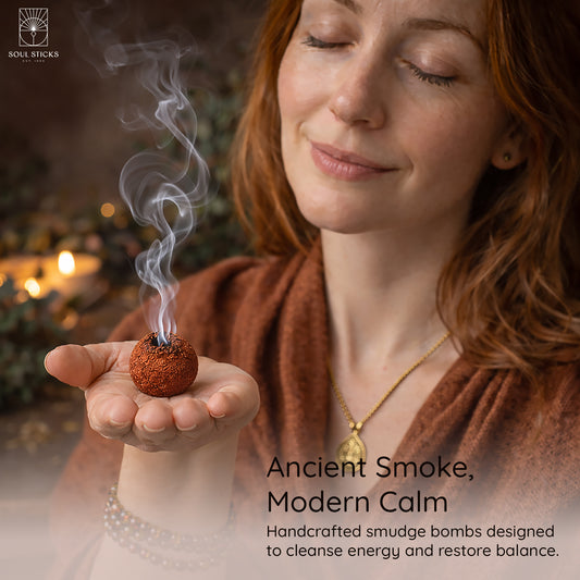 Hand holding a lit cedar & pine smudge bomb with smoke