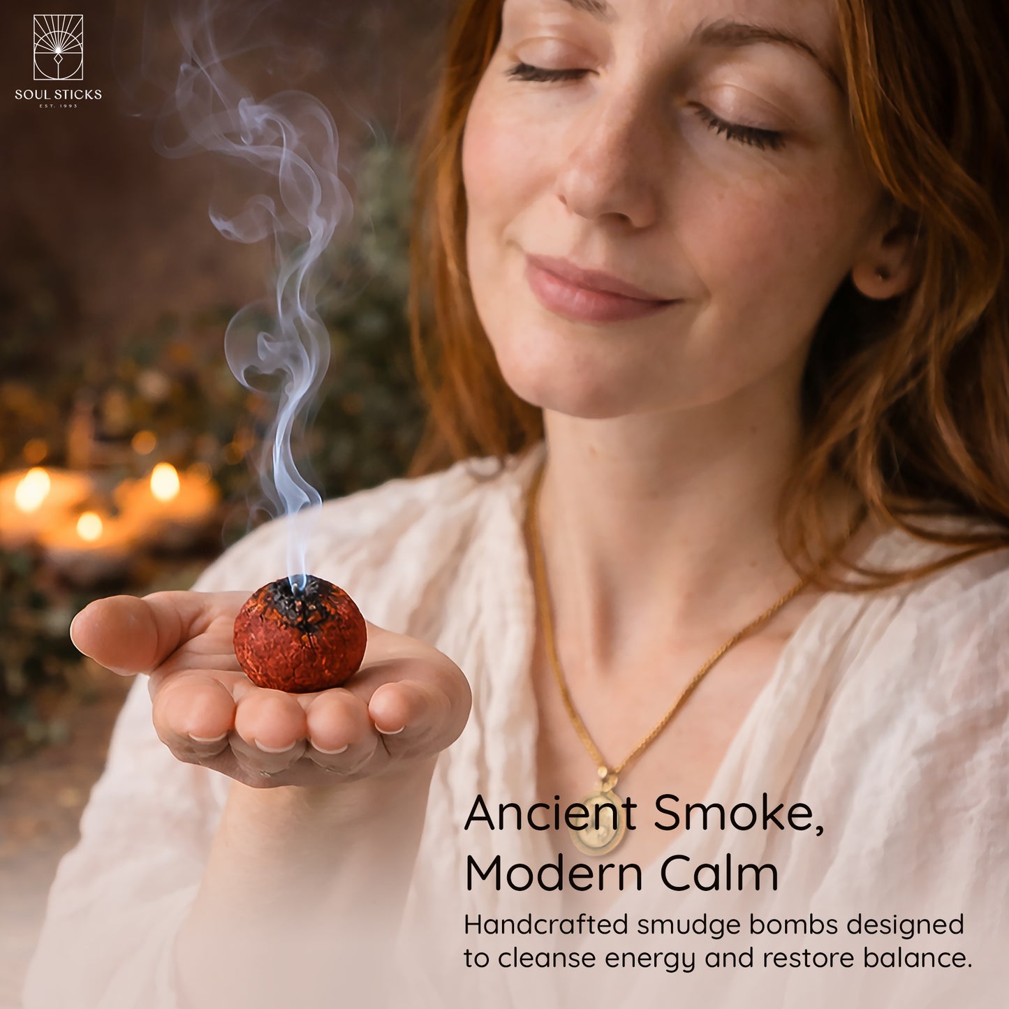 Hand holding a lit dragon's blood smudge bomb with smoke