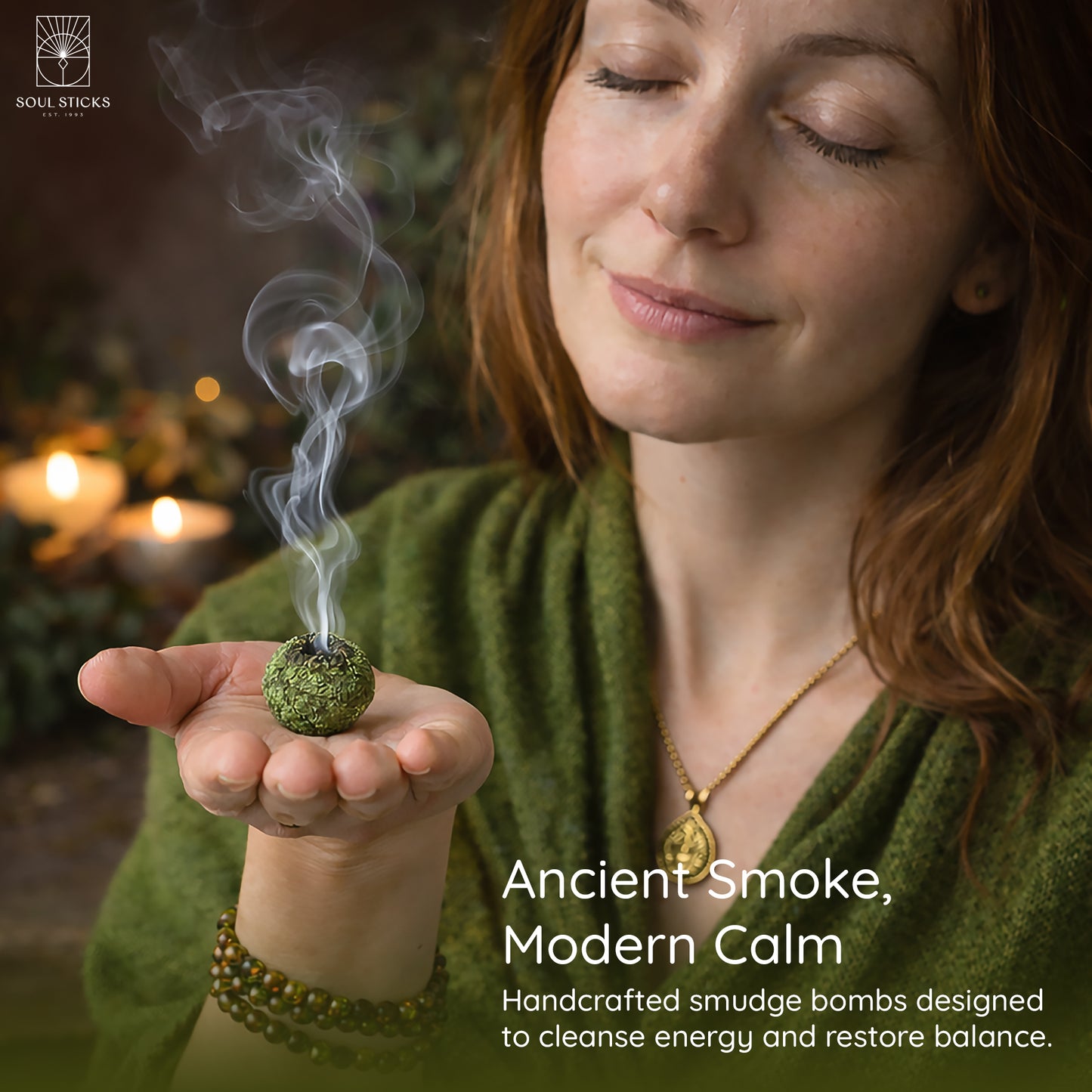Hand holding a lit sweetgrass braids smudge bomb with smoke